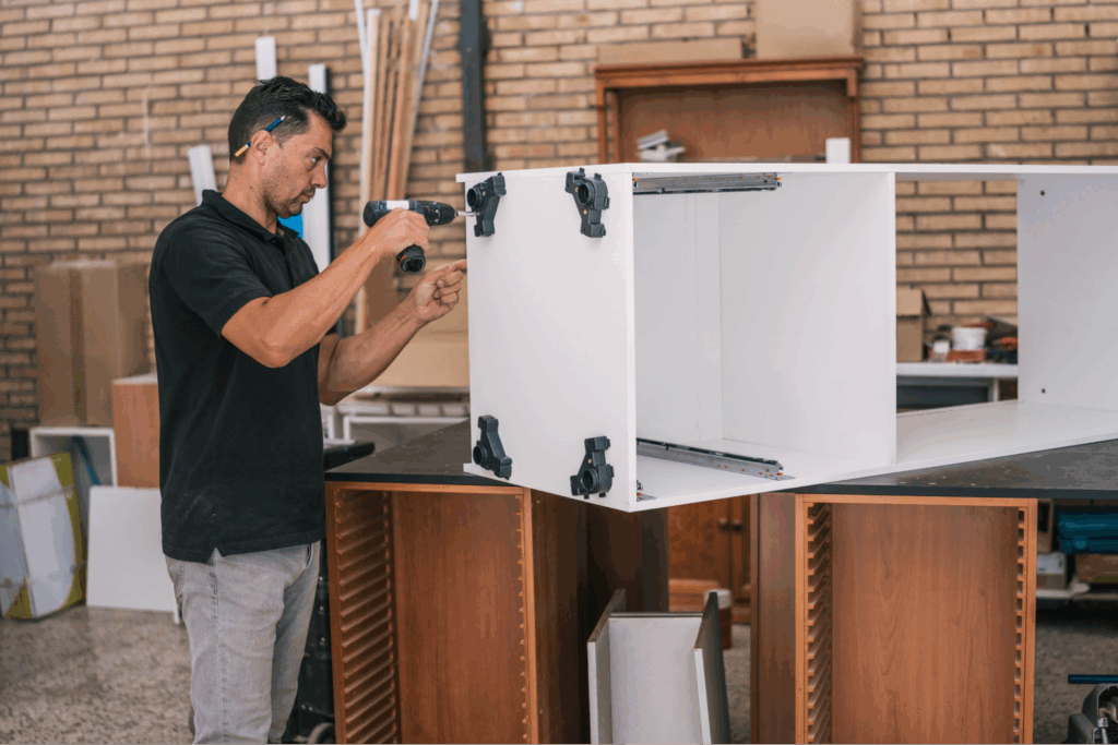 A man building a cabinet.