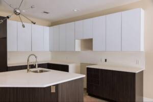 Upgrading kitchen with new sink tap set in a freshly installed modern cabinet.