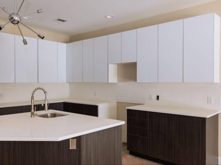 Upgrading kitchen with new sink tap set in a freshly installed modern cabinet.