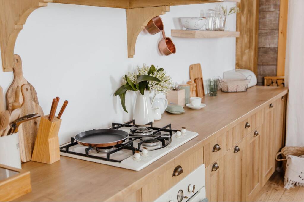A side view of a kitchen with wooden cabinets.