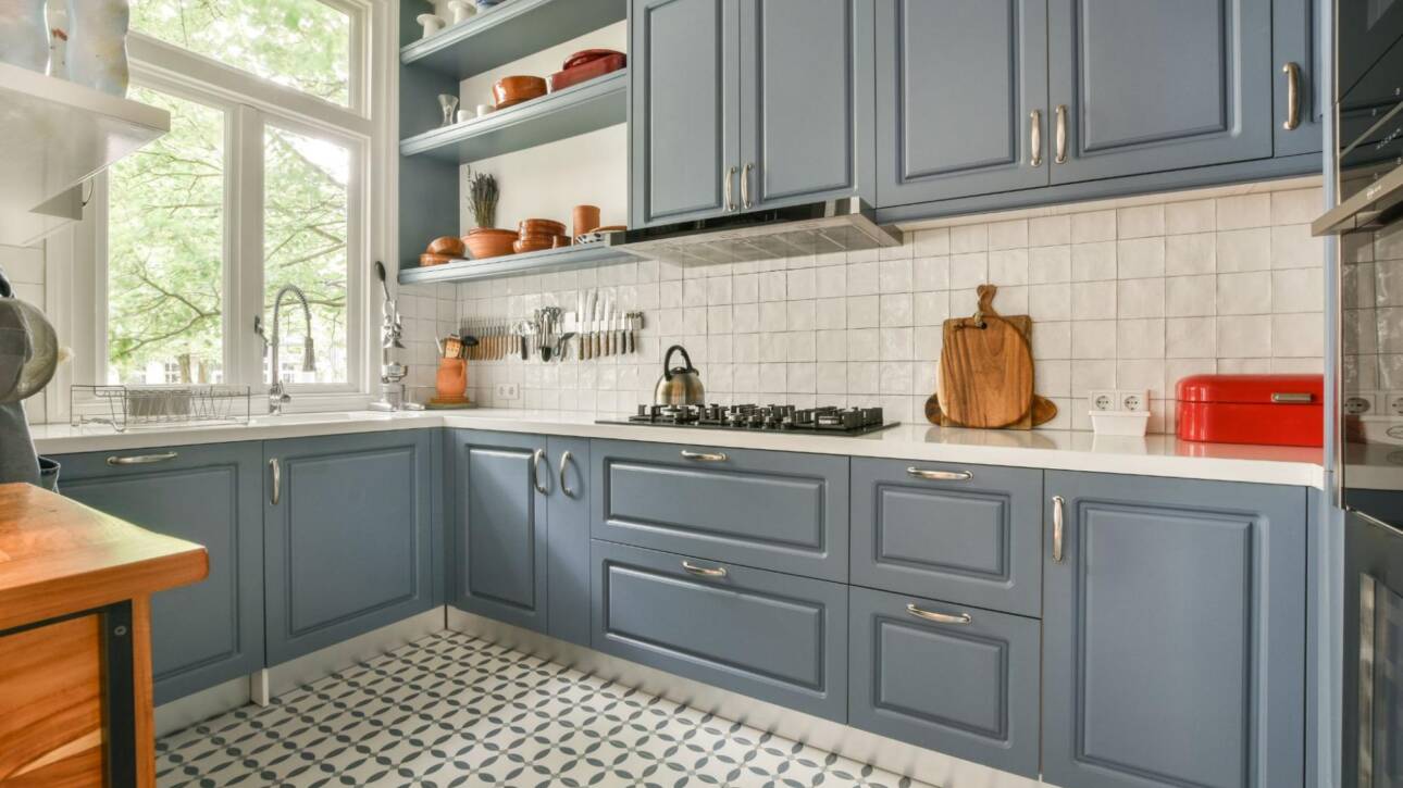 A modern kitchen with blue cabinets.