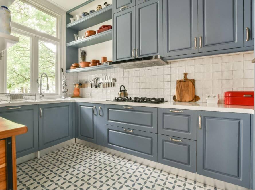 A modern kitchen with blue cabinets.