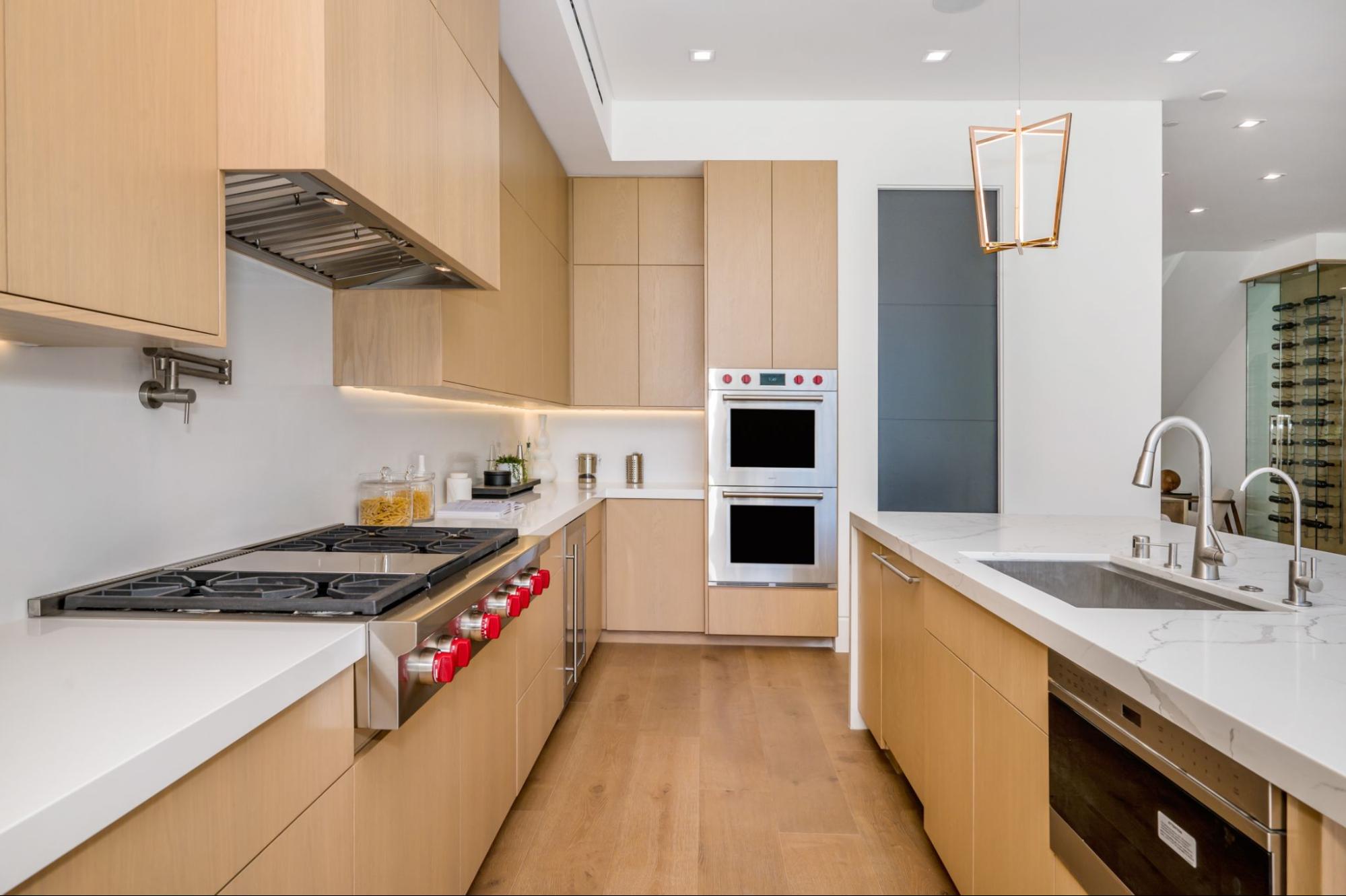 A compact kitchen featuring minimalist modern cabinets that create an open, airy feel.